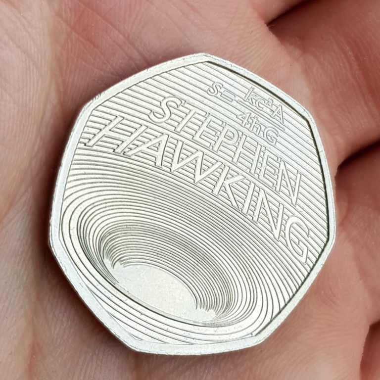 Stephen Hawking 50p held in palm